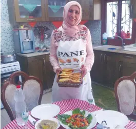  ?? (Laura Kelly) ?? SHFARAM HOMEMAKER Manal Karamal Jabereel prepares an iftar feast in her home kitchen yesterday.