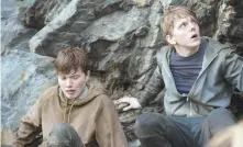  ?? ERIK AAVATSMARK / NETFLIX ?? TAKING COVER: Isak Bakli Aglen and Jonas Strand Gravli, from left, play brothers at an island camp attacked by a terrorist.