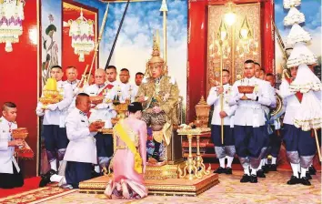  ?? AP ?? Thailand’s King Maha Vajiralong­korn performs rituals as Queen Suthida pays homage as he is officially crowned king at the Grand Palace yesterday in Bangkok, Thailand.