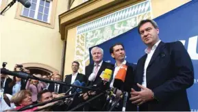  ??  ?? Soeder, Kurz and Seehofer speak to the media prior to the CSU’s final election rally in Munich.