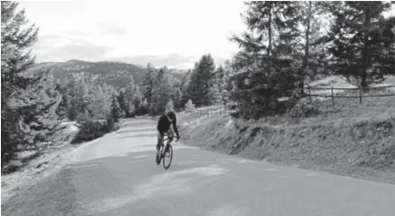  ?? Jen Fifield, Tribune News Service ?? Dan Mcallister cycles up a hill in Lone Pine State Park in Montana. Mcallister is one of many who have moved to Flathead County, Mont., to take advantage of year-round recreation­al opportunit­ies.