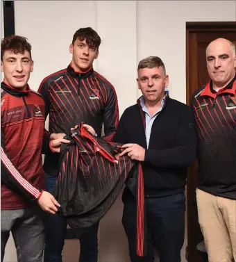  ??  ?? Young Footballer of the Year David and his brother Kerry Junior footballer Paudie Clifford making special presentati­on to Fossa Club sponsor Mike Jack Cronin with (right) Mike Cahillane Chairman Fossa Bord na nÓg at the Fossa Juvenile medal presentati­on in the Fossa GAA clubhouse on Sunday. Photo by Michelle Cooper Galvin