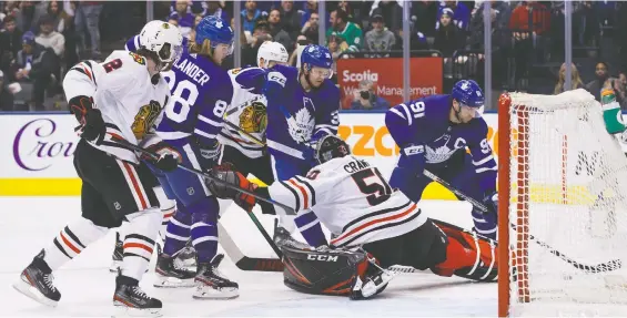  ?? COLE BURSTON/THE CANADIAN PRESS FILES ?? For players like William Nylander, left, and Rasmus Sandin, middle, of the Maple Leafs, staying put for now means avoiding a 14-day quarantine.