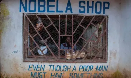  ?? Photograph: Amos Gumulira/AFP/Getty Images ?? A grocer sits with four loaves of bread in Lilongwe, Malawi. Africans are feeling the impact ofthe Ukraine crisis in increases in the price of grain, as well as fuel and fertiliser.