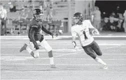  ?? JASON BEEDE ?? Timber Creek wide receiver Ryan Campbell runs past an Oviedo defender after making a catch Friday night.