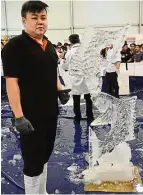  ??  ?? Liao with his award- winning ice- carving sculpture, the ‘ kissing fish’.