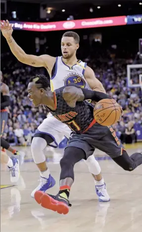  ?? MARCIO JOSE SANCHEZ / AP ?? Atlanta Hawks' Dennis Schroder drives past Stephen Curryof the Golden State Warriors during Monday’s game in Oakland, California. Golden State won 105-100.