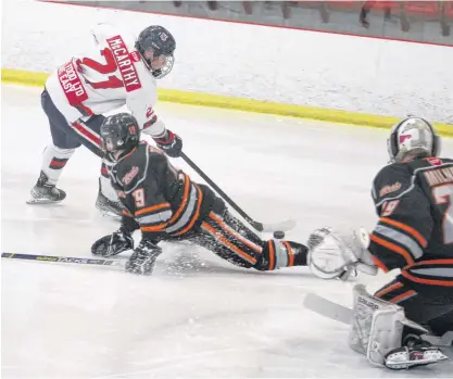  ?? JASON MALLOY PHOTOS ?? Kohltech Valley Wildcats forward Ben McCarthy tries to get a backhand shot over Cape Breton West Islanders defenceman Jack Taylor during under-18 major hockey playoff action March 20 at the Kings Mutual Century Centre in Berwick.