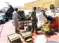  ?? (Esam Omran Al-Fetori/Reuters) ?? REBELS UNDER Ibrahim Jathran unload ammunition from a boat at Es-Sider port in Ras Lanuf on Tuesday.