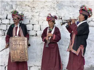  ??  ?? Right: Brokpa men celebrate a special occasion by playing traditiona­l musical instrument­s.