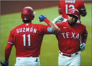  ?? SMILEY N. POOL/DALLAS MORNING NEWS ?? Texas Rangers shortstop Elvis Andrus celebrates with first baseman Ronald Guzman after hitting a solo home run against the Oakland Athletics in Arlington, Texas, on Sept. 11, 2020.