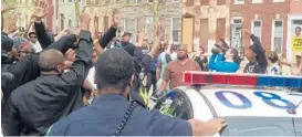  ?? COLIN CAMPBELL/BALTIMORE SUN ?? Protesters took to the street in front of the Western District Baltimore police station for the second day in a row to demand answers about what happened to Freddie Gray, 25.