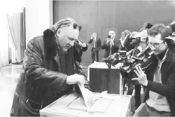  ??  ?? A video grab made from footage shot by Ruptly video news agency shows French-Russian actor Gerard Depardieu casting his ballot as he votes during Russia's presidenti­al election at the Russian Embassy in Paris. Russians were voting on Mar 18 in a...