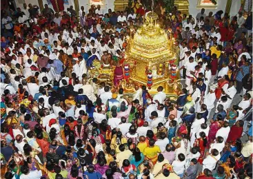  ??  ?? Golden journey: The golden chariot carrying the ‘vel’ departing for its maiden journey from the Sri Maha Mariamman Temple at Queen Street, Penang.