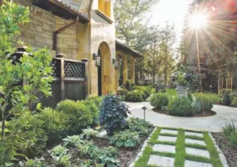  ??  ?? Lifescape Associates installed curvilinea­r paths and square-cut flagstones set into checkerboa­rd walkways in the lawn. Photos by Ron Ruscio, provided by Lifescape Associates Inc.