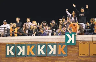  ?? Eric Risberg / Associated Press ?? Fans cheer as another K is put on the right-field wall after Giants starter Madison Bumgarner struck out the Padres’ Clint Barmes in the sixth. Bumgarner finished with nine strikeouts.