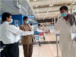  ??  ?? MORE TO GO: Passengers of the first special flight that repatriate­d 227 Pakistanis at Dubai airport. Workers who lost jobs are seeking discounts on airfare.