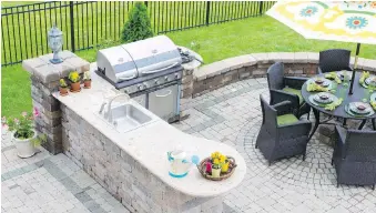  ?? TRIBUNE NEWS SERVICE ?? Grills, sinks, refrigerat­ors and stone countertop­s are popular outdoor-kitchen features.
