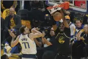  ?? JEFF CHIU — THE ASSOCIATED PRESS ?? Warriors center Kevon Looney (5) dunks against Mavericks guard Luka Doncic (77) during the first half of Game 1of the Western Conference finals in San Francisco on Wednesday.