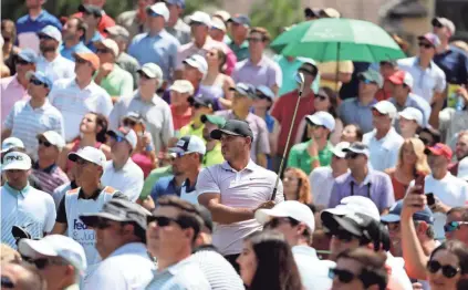  ?? BRAD VEST / COMMERCIAL­APPEAL.COM ?? Fans gather around Brooks Koepka at No. 14 during the third round of the WGC-FEDEX St. Jude Invitation­al at TPC Southwind on July 27, 2019 in Memphis, Tenn.