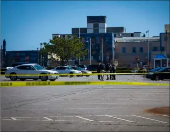  ?? AP Photo/John C. Clark ?? Virginia Beach police work the scene of a shooting the night before on Saturday in Virginia Beach, Va.