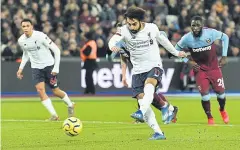  ?? AFP ?? Liverpool’s Mohamed Salah shoots from the penalty spot to score his team’s opening goal.