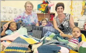  ?? Picture: MARK WEST ?? WINTER WOOLLIES: Former Aurora hospital patient Joy Sharpe, back left, after she gave knitted blankets to the children in the hospital’s special care centre. Principal Zelda Claassen, right, received the blankets on the children’s behalf