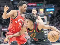  ?? TONY DEJAK THE ASSOCIATED PRESS ?? Cavalier Collin Sexton, who has a franchise record of threes as a rookie, drives past Raptor Kyle Lowry in the first half on Monday.