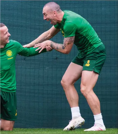  ??  ?? Scott Brown shares a joke with Leigh Griffiths and Jonny Hayes during a training session