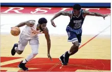  ?? DAVID JABLONSKI / STAFF ?? UD’s Josh Cunningham dribbles beside Rhode Island’s Nicola Akele on Saturday at UD Arena, where the Rams defeated the Flyers 88-74.