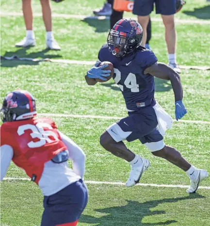  ?? JOSHUA TAYLOR MCCOY/OLE MISS ATHLETICS ?? Running back Ulysses Bentley IV carries the ball during a spring practice on March 31.