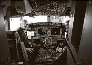  ?? Mike Simons / Associated Press ?? Pilots Peter Gamble, left, and John Konstanzer talk to journalist­s after a flight from Dallas to Tulsa, Okla. Some who lost relatives in two crashes question the motives behind the media flights.