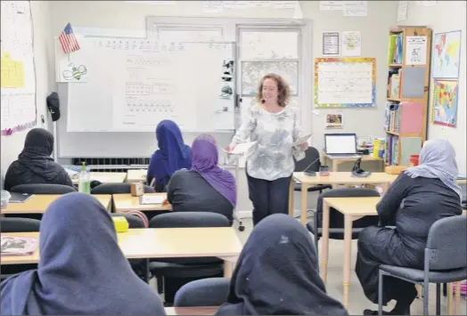  ?? Photos by John Carl D’annibale / Times Union ?? Patty Jokiel teaches an English class on Tuesday at the RISSE center in Albany. RISSE, which stands for Refugee and Immigrant Support Services of Emmaus, offers assistance to refugees and other immigrants, including classes for adults and after-school programs for children.