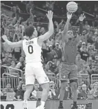  ?? PHELAN M. EBENHACK/AP ?? Furman guard JP Pegues (1) makes the game-winning basket as Virginia guard Kihei Clark defends Thursday in Orlando, Fla.
