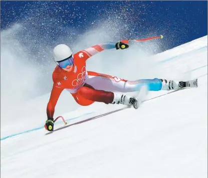  ?? GETTY IMAGES ?? Corinne Suter from Switzerlan­d competes in the women’s downhill at the 2022 Olympic Games on Feb 15. Suter, 27, who injured both knees just before the start of the season, edged defending Olympic champion Sofia Goggia by 0.16 seconds to win the downhill race.