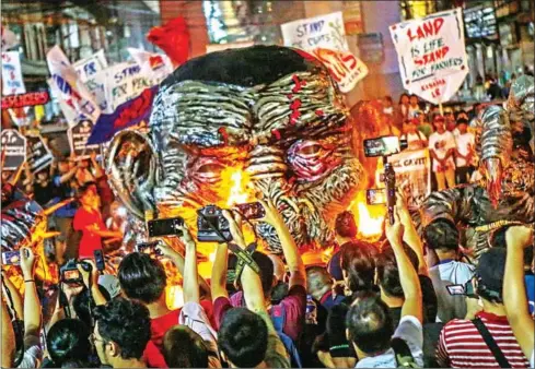  ?? AFP ?? Protesters burn an effigy of Philippine­s’ President Rodrigo Duterte during a rally commemorat­ing Internatio­nal Human Rights Day in Manila in December. Duterte has waged a deadly war on drugs that has claimed thousands of lives.