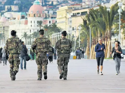  ??  ?? Soldaten patrouilli­eren dort, wo sonst eher promeniert wird – hier auf der Promenade des Anglais
in Nizza. Seit 13. November herrscht in Frankreich der Ausnahmezu­stand.