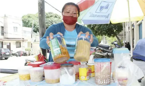  ?? ?? SMALL ENTREPRENE­UR.
A street vendor shows the ingredient­s of the halo-halo at her stall. The dessert, made of crushed ice, milk, and a variety of ingredient­s such as kaong, nata de coco, ube halaya and leche flan, is a popular snack, especially during summer months. According to presidenti­al adviser for entreprene­urship Joey Concepcion, the next administra­tion should prioritize job generation as many businesses struggled during the COVID-19 pandemic.