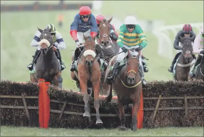  ??  ?? Old Guard ridden by Harry Cobden, second left, on their way to victory in the 2015 Greatwood Hurdle at Cheltenham.