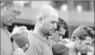  ?? Democrat-Gazette file photo ?? Arkansas Travelers players and coaches take part in a moment of silence at Dickey-Stephens Park in North Little Rock on July 24, 2007, two days after Tulsa Drillers base coach Mike Coolbaugh died after being struck by a foul ball during a game at the...