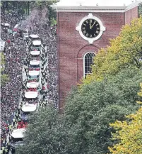  ?? MADDIE MEYER GETTY IMAGES ?? The Boston Red Sox ride in duck boats on Tremont St. past Park Street Church during the team’s victory parade.