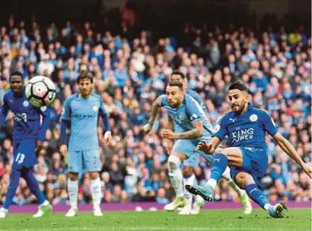  ?? AFP PIC ?? Leicester City’s Riyad Mahrez slips while taking his penalty against Manchester City at the Etihad Stadium yesterday.