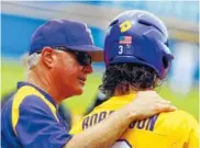  ??  ?? LSU coach Paul Mainieri talks with Kramer Robertson during the first inning of the championsh­ip game against Arkansas in the Southeaste­rn Conference tournament Sunday. LSU won the tourney title and is one of eight SEC teams headed to the College World...