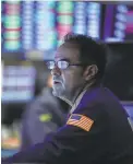  ?? SPENCER PLATT/GETTY IMAGES ?? A trader works at the New York Stock Exchange on Monday.