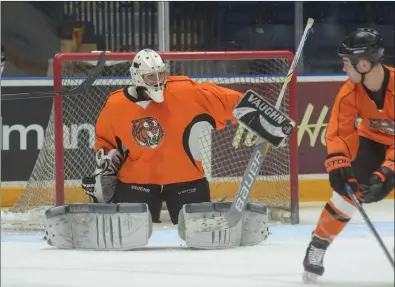  ?? NEWS PHOTO MO CRANKER ?? Tigers goaltender Darrick Bauman makes a stop during the first period of the Linden Cup Friday at the Canalta Centre. It is the fourth straight year of the event that raised between $24-28,000 that will be split between the Medicine Hat and District...