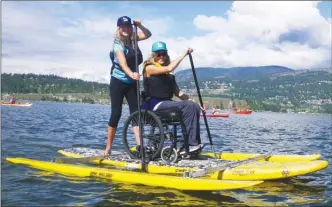  ?? J.P. SQUIRE/Special to The Daily Courier ?? The official launch of the Kelowna Paddle Trail recently attracted a wide variety of human-powered watercraft. One of the most unusual was a pontoon boat equipped to carry a wheelchair with its two riders using paddleboar­d paddles to go from City Park...