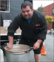  ?? LAUREN HALLIGAN — DIGITAL FIRST MEDIA ?? Chef and owner Brad Stevens of B-rad’s Bistro &amp; Catering stirs up some seafood chowder during the 12th annual Troy Chowderfes­t.