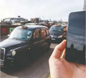  ?? CHRIS J RATCLIFFE / GETTY IMAGES FILES ?? Britain's Supreme Court ruled Friday that ride-hailing giant Uber must treat its drivers
as workers, giving them access to minimum wage, rest breaks and vacation pay.