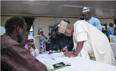  ?? Photo: Itodo Daniel Sule ?? APC governorsh­ip candidate in the November 16 governorsh­ip election in Kogi State, Governor Yahaya Bello, signs the peace accord during the INEC's stakeholde­rs' meeting in Lokoja yesterday