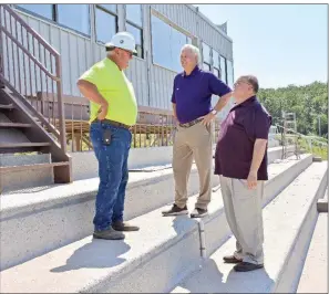  ?? STACI VANDAGRIFF/RIVER VALLEY & OZARK EDITION ?? Randall Hettinga, from left, constructi­on manager for Van Horn Constructi­on; Mayflower Superinten­dent John Gray; and John Pipkins, the school district’s curriculum and federal program director, discuss the upgrades to the school’s athletic facilities. Work is being done to upgrade the home bleachers for the fall, but the visitor’s side will eventually be the home seats. The $5.65 million project includes a field house and artificial turf on the football field.
